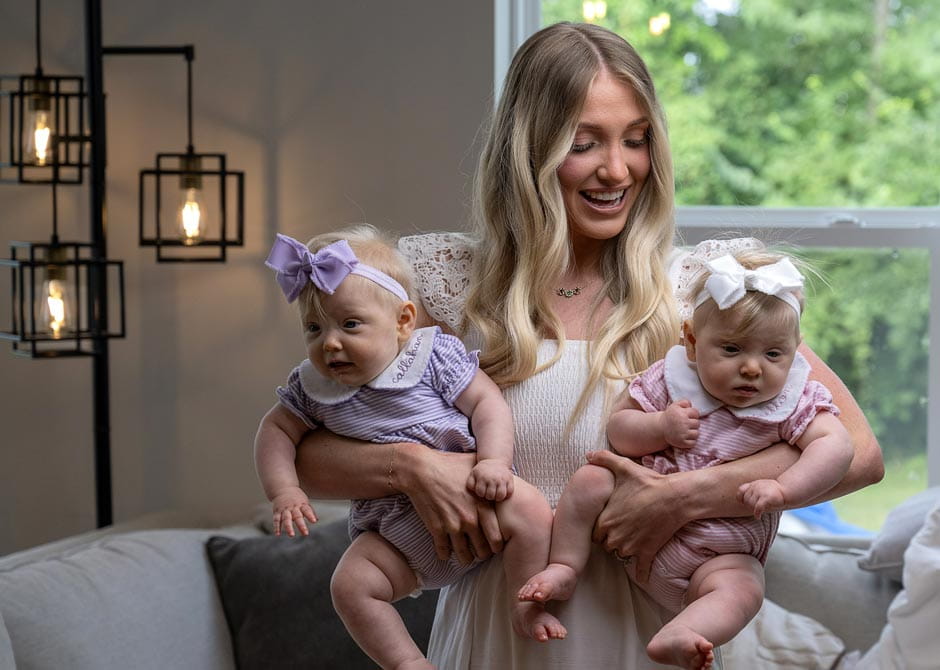 woman holding her 2 twin children