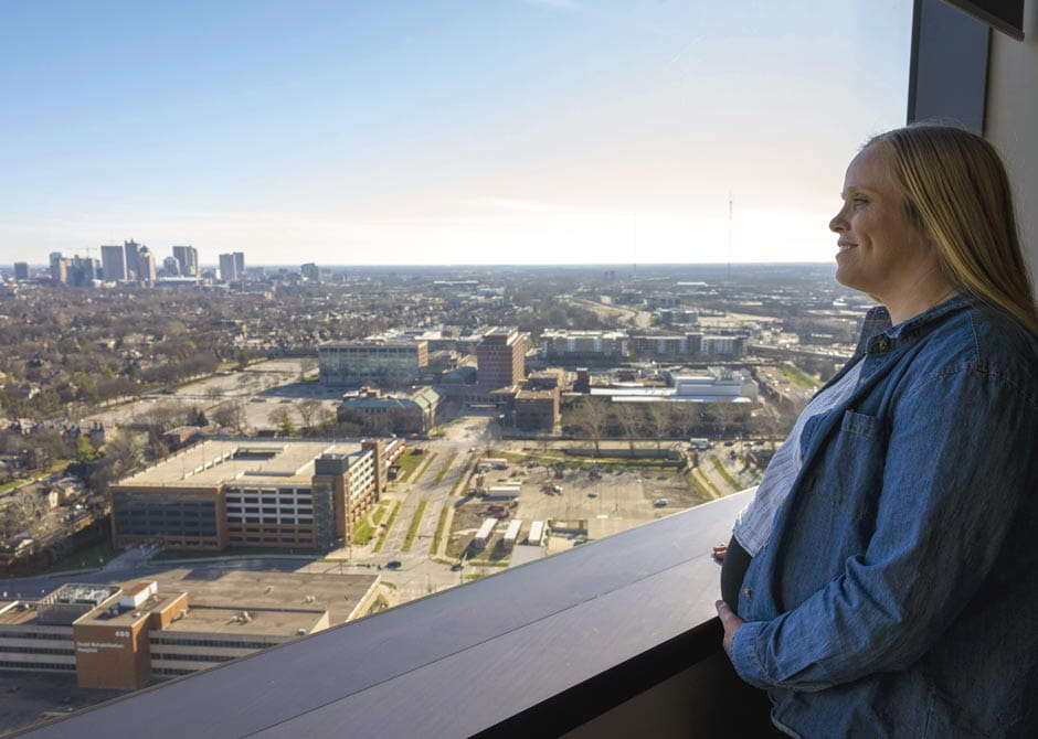 pregnant woman looking out of hospital room at downtown Columbus Ohio