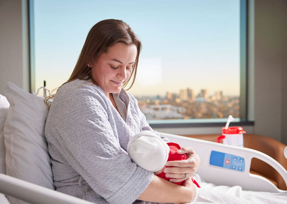 mom in hospital bed with newborn baby