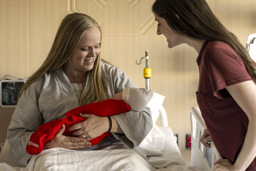 Mother with new baby in hospital bed
