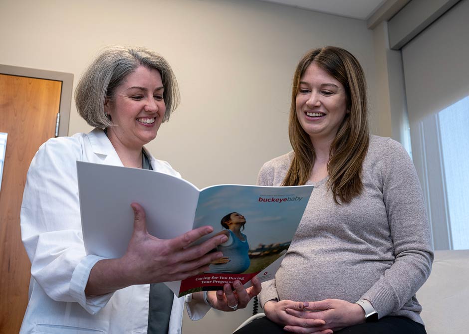 pregnant woman talking with doctor