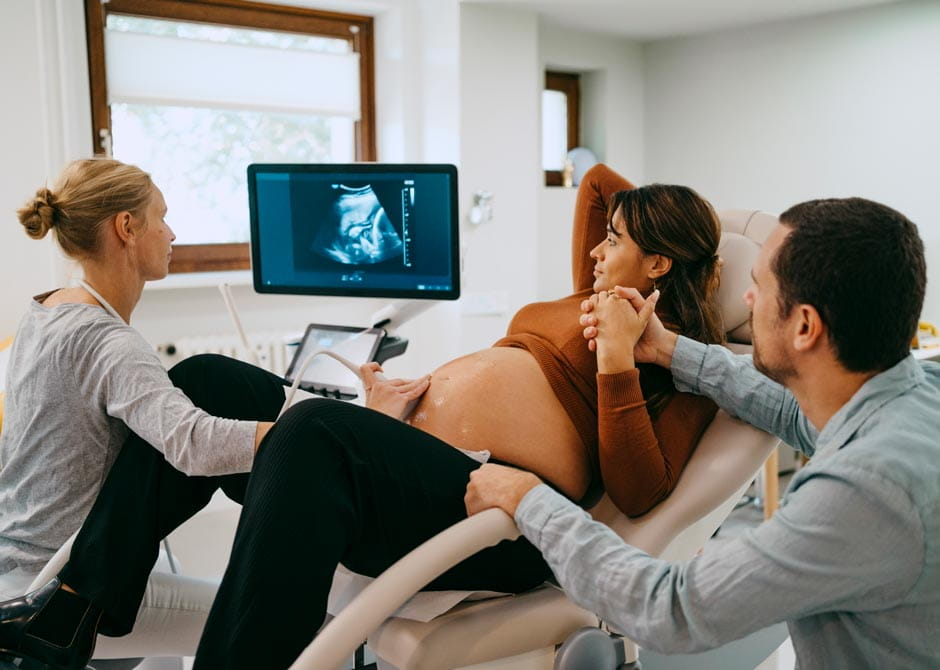 Doctor doing ultrasound of pregnant woman