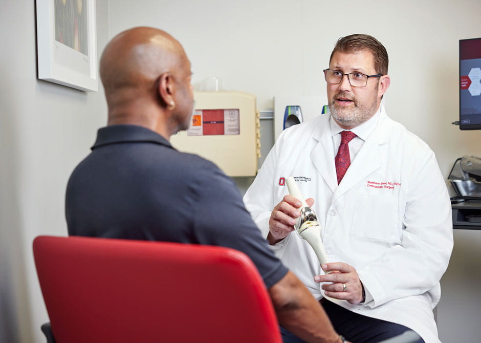 Dr. Matthew Beal talking to patient about Knee Replacement