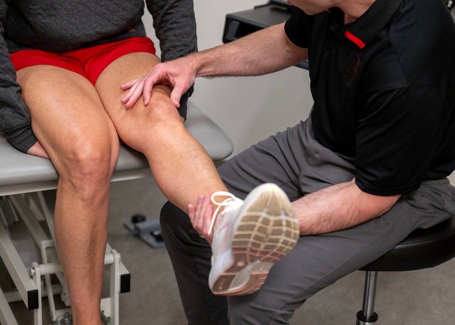 Dr. Baria performing a knee exam