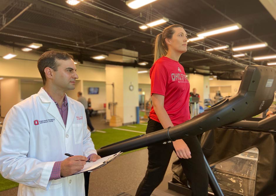 Dr. Tiso with concussion treatment patient on treadmill