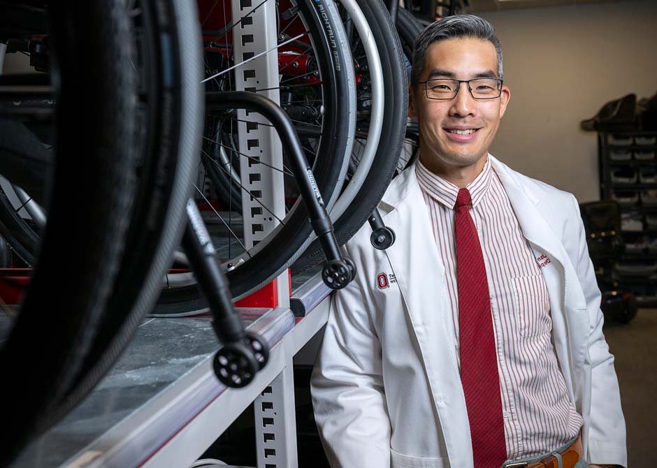 Doctor posing with wheelchairs