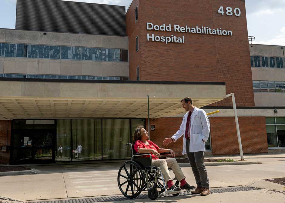 Dr. Timothy Hake with a patient in front of Dodd Rehabilitation Hospital