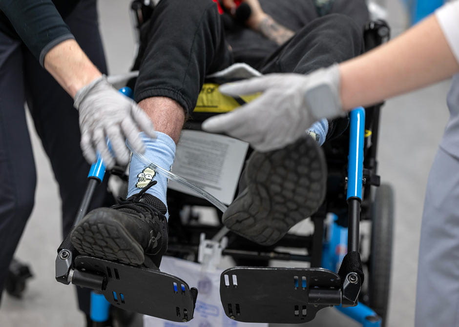 Providers assisting patient in wheelchair