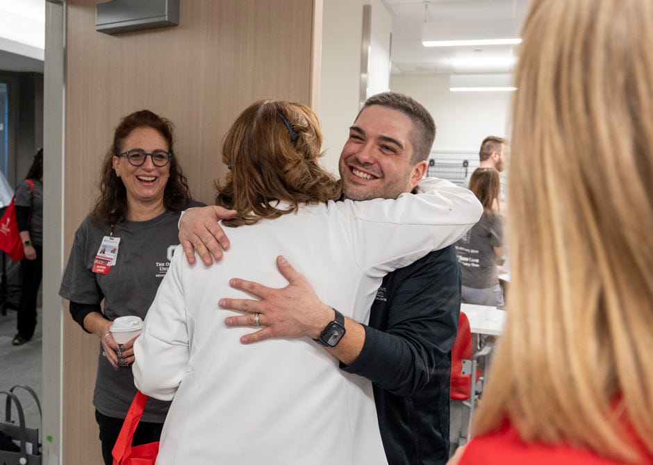 A rehabilitation patient hugging their doctor