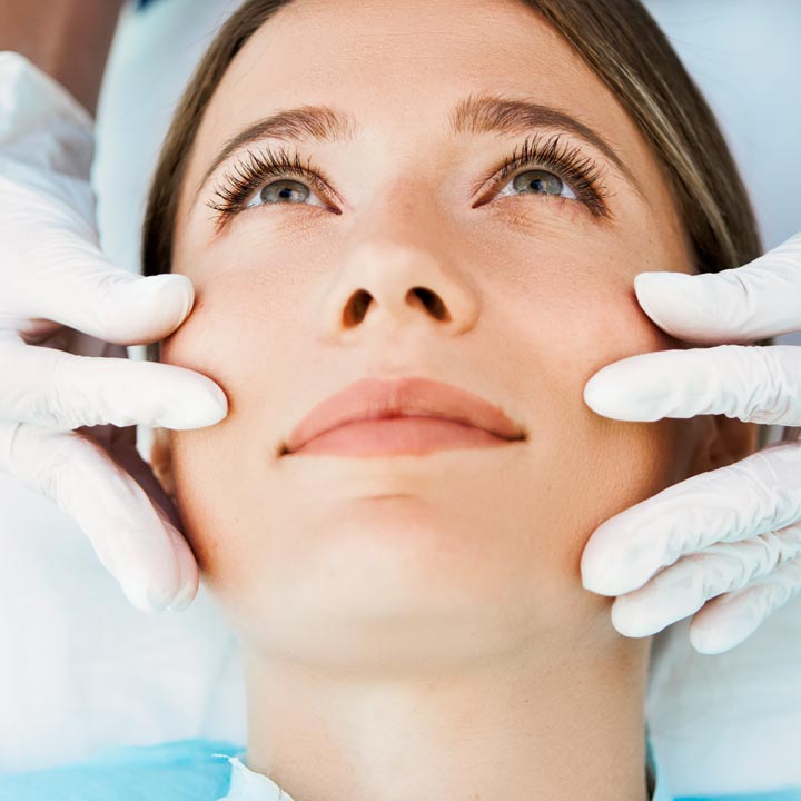 Woman having her face examined for a rhinoplasty