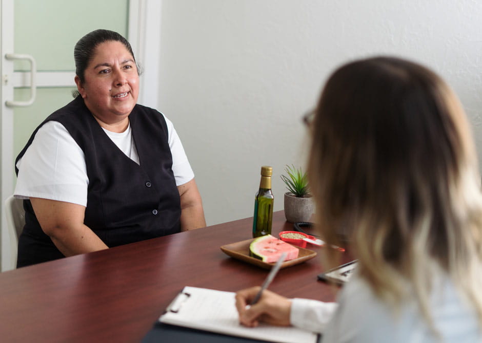 Overweight woman consulting nutritionist at office