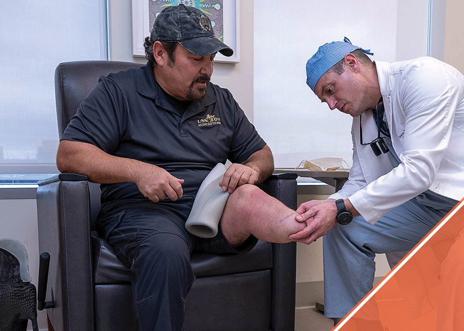 Dr. Souza examining a patient with an amputated leg