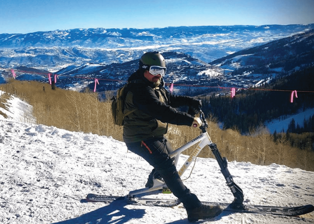 Shane Jernigan in winter sports gear on a snow-covered mountain